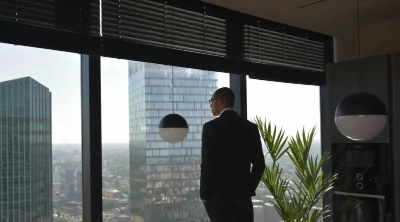 erspectiva de mando estratégico en oficina de alto nivel; silueta de directivo frente a skyline urbano, simbolizando la protección de legado y la infraestructura de privacidad.